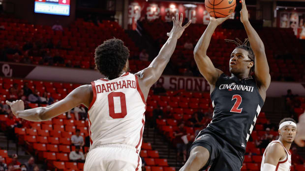 Mar 5, 2024; Norman, Oklahoma, USA; Cincinnati Bearcats guard Jizzle James (2) shoots over Oklahoma Sooners guard Le'Tre Darthard (0) during the first half at Lloyd Noble Center. Mandatory Credit: Alonzo Adams-USA TODAY Sports